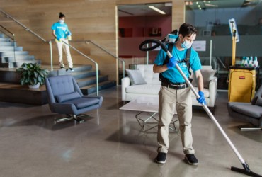 Two ServiceMaster Clean janitors cleaning an office reception area and lobby